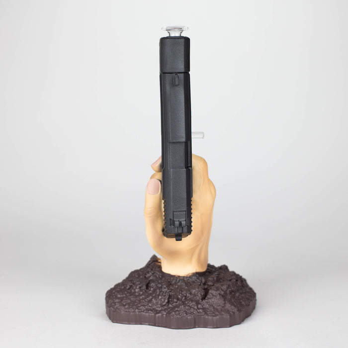 A bong with a pistol in hand